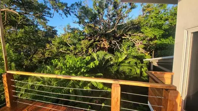 a balcony with a view of trees and plants at Casa Boa Casita Tambor in La Abuela
