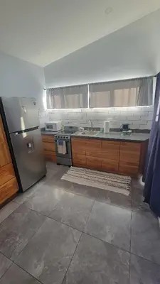 a kitchen with a stainless steel refrigerator and a sink at Casa Boa Casita Tambor in La Abuela