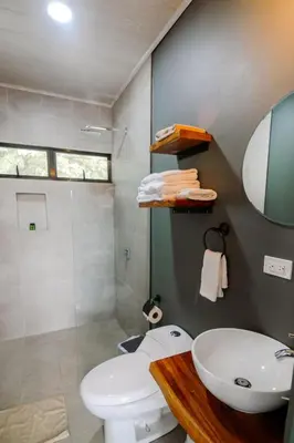 a bathroom with a toilet and a sink and a shower at Casa Ola Ini Studio Playa Grande in Playa Grande