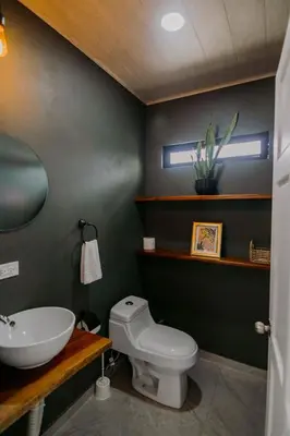 a bathroom with a white toilet and a sink at Casa Ola Ini Studio Playa Grande in Playa Grande