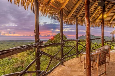 a porch of a resort with a view of the ocean at TikiVibez in Coronado