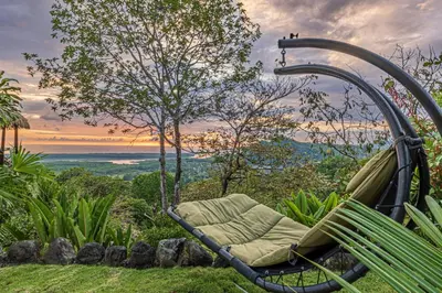 a swinging bench in a garden with a view at TikiVibez in Coronado