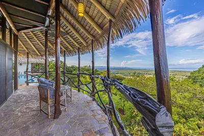a porch of a house with a view of the ocean at TikiVibez in Coronado