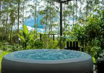 a hot tub in the middle of a garden at Paradise Views Awaits, King Bed, Hot-Tub in Quebradas
