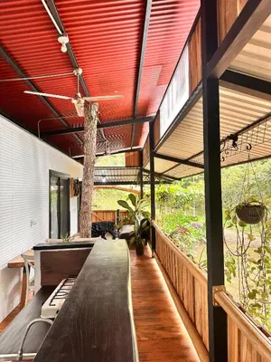 an outdoor kitchen with a long table in a house at Casa Laurel in Santa Cruz
