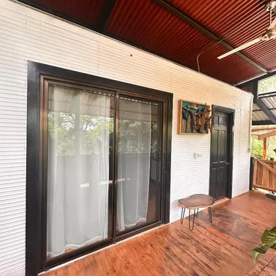 a screened in porch with a chair and a window at Casa Laurel in Santa Cruz