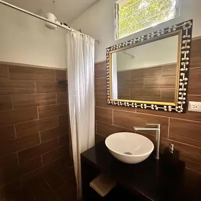 a bathroom with a sink and a mirror at Casa Laurel in Santa Cruz