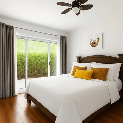 a white bed with yellow pillows and a window at Apartamento moderno con vista al río, piscinas y gym Costa Rica in Santa Ana