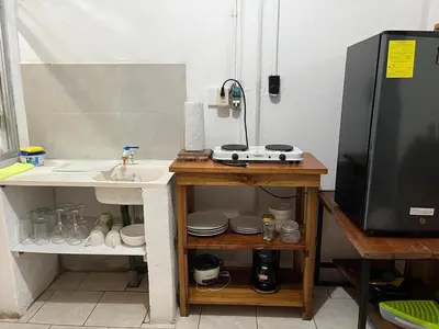 a small kitchen with a sink and a counter with a sink at El Jardín de Tere in Bijagua