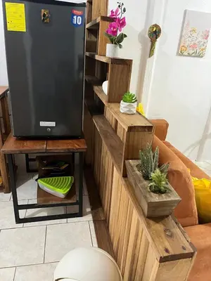 a living room with a tv on a wooden wall at El Jardín de Tere in Bijagua