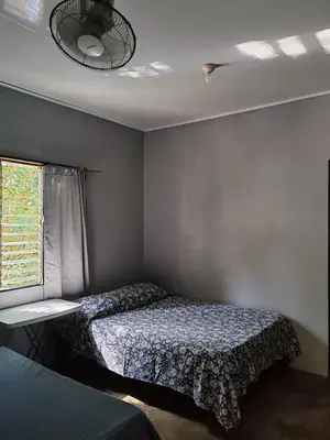 a small bedroom with a bed and a window at Apartamentos el Espavel in Santa Teresa Beach