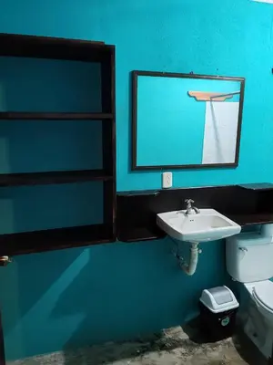 a blue bathroom with a sink and a mirror at Apartamentos el Espavel in Santa Teresa Beach