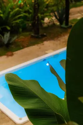 a laptop computer sitting next to a swimming pool at Unique design and cozy property in Playa Hermosa