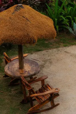 a table and a chair with an umbrella on it at Unique design and cozy property in Playa Hermosa