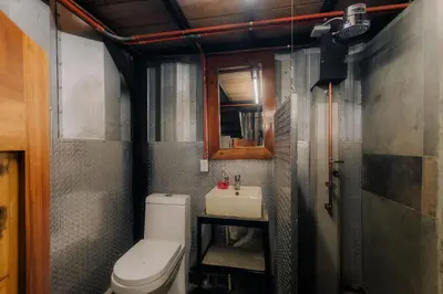 a small bathroom with a toilet and a sink at Unique design and cozy property in Playa Hermosa