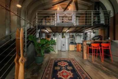 a kitchen with a loft with a table and chairs at Unique design and cozy property in Playa Hermosa