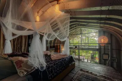 a bedroom with a bed with mosquito netting at Unique design and cozy property in Playa Hermosa