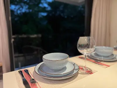 a table with a bowl and a glass of wine at Modern Haven with Forest Views and Ocean Breeze in Jacó