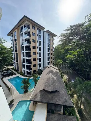 an aerial view of a resort with a swimming pool and a building at Modern Haven with Forest Views and Ocean Breeze in Jacó