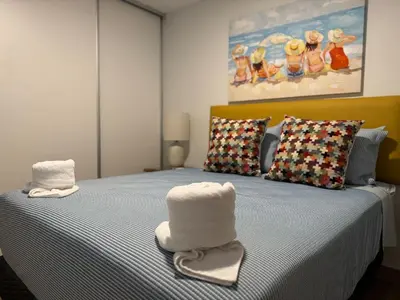 a bedroom with a bed with two hats on it at Modern Haven with Forest Views and Ocean Breeze in Jacó