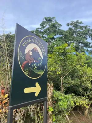 a sign for a wildlife sanctuary with a monkey on it at Villa Guarumo in Santa Eulalia