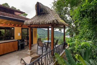 a gazebo with a table and chairs on a patio at Casa Mareas in Dominicalito