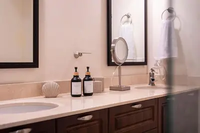 two bottles of wine sitting on a bathroom counter at Casa Mareas in Dominicalito