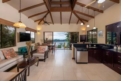 a kitchen and living room with a view of the ocean at Casa Mareas in Dominicalito