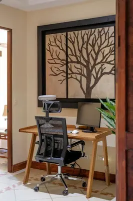 an office with a desk with a chair and a computer at Casa Mareas in Dominicalito