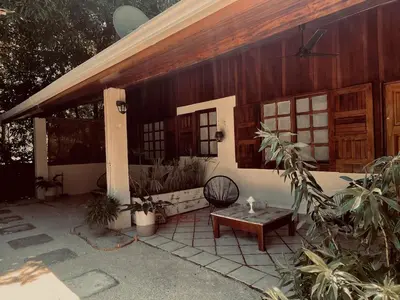 a porch of a house with a table in front of it at Nagomi Casita #1 in Sámara