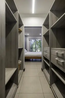 a walk in closet with a bed in the background at Corporate Stays Urban Flats Studio in San Rafael