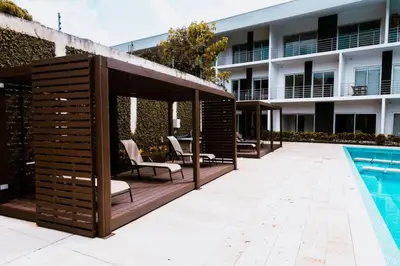 a large wooden gazebo next to a swimming pool at Corporate Stays Urban Flats Studio in San Rafael