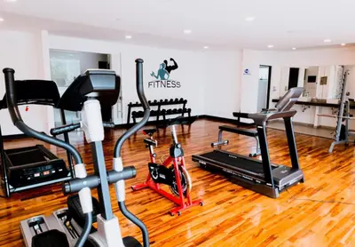a gym with treadmills and elliptical machines at Corporate Stays Urban Flats Studio in San Rafael