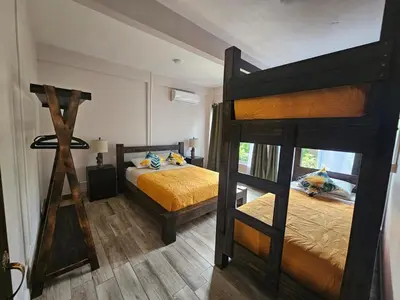 a bedroom with two bunk beds in a room at Kame House, Tortuguero in Tortuguero