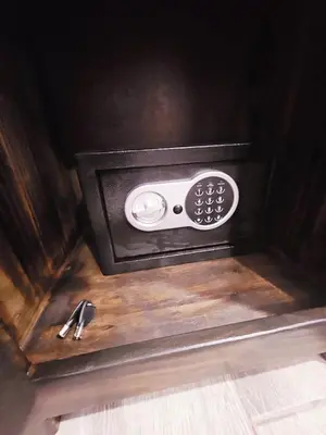 a remote control sitting on top of a wooden table at Kame House, Tortuguero in Tortuguero