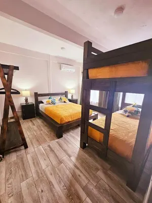 two bunk beds in a room with wooden floors at Kame House, Tortuguero in Tortuguero