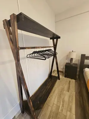 a wooden shelf in a room with a bed at Kame House, Tortuguero in Tortuguero