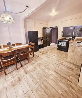 a kitchen and dining room with a table and a counter at Kame House, Tortuguero in Tortuguero