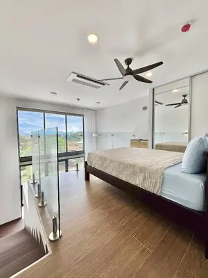 a bedroom with a bed and a ceiling fan at Brand New Loft Few Steps From The Beach in Jacó