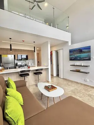 a living room with a couch and a table at Brand New Loft Few Steps From The Beach in Jacó