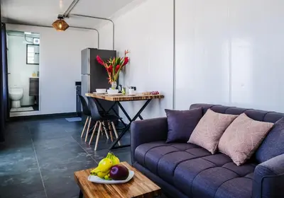 a living room with a purple couch and a table at The DEN in Tamarindo