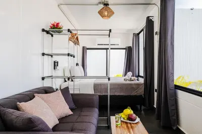 a living room with a couch and a bed at The DEN in Tamarindo