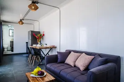 a living room with a purple couch and a table at The DEN in Tamarindo