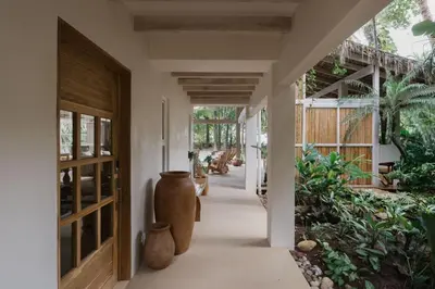 a hallway with two large vases in a house at Gorgeous beachfront villa with private pool in Santa Teresa Beach