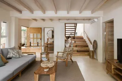 a living room with a couch and a table at Gorgeous beachfront villa with private pool in Santa Teresa Beach