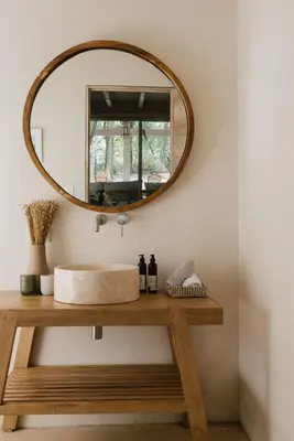 a bathroom with a sink and a mirror on a table at Gorgeous beachfront villa with private pool in Santa Teresa Beach