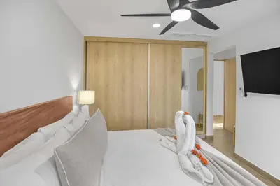 a bedroom with a bed with towels on it at Heavenly View - 2 BDRM Oceanview Apartment in Jacó
