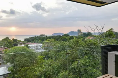a view of the ocean from the balcony of a house at Heavenly View - 2 BDRM Oceanview Apartment in Jacó