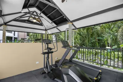 a fitness room with a treadmill and a balcony at Heavenly View - 2 BDRM Oceanview Apartment in Jacó