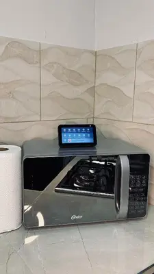 a tablet sitting on top of a stove in a kitchen at Kens Lower department in Quepos